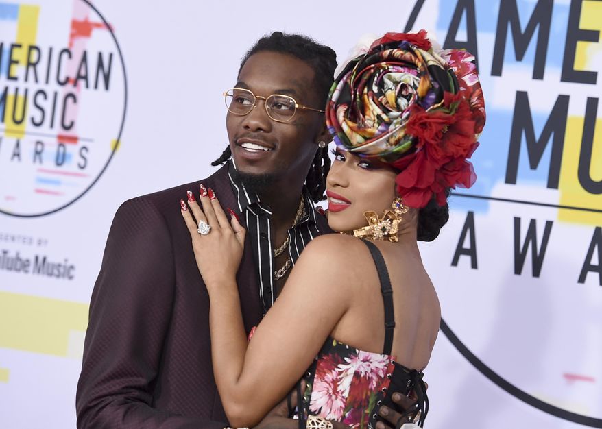 FILE - In this Oct. 9, 2018, file photo, Offset, left, and Cardi B arrive at the American Music Awards at the Microsoft Theater in Los Angeles. Cardi B is no longer feeling the love after little more than a year of marriage to fellow rapper Offset. (Photo by Jordan Strauss/Invision/AP, File)