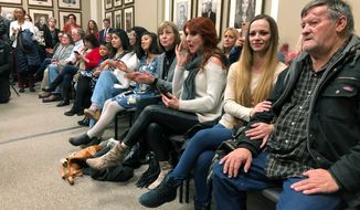 Family members and supporters of 21 Oklahoma prison inmates react in Oklahoma City on Wednesday, Dec. 5, 2018, after Gov. Mary Fallin signed commutations for mostly female offenders sentenced for drug crimes. (AP Photo/Sean Murphy)