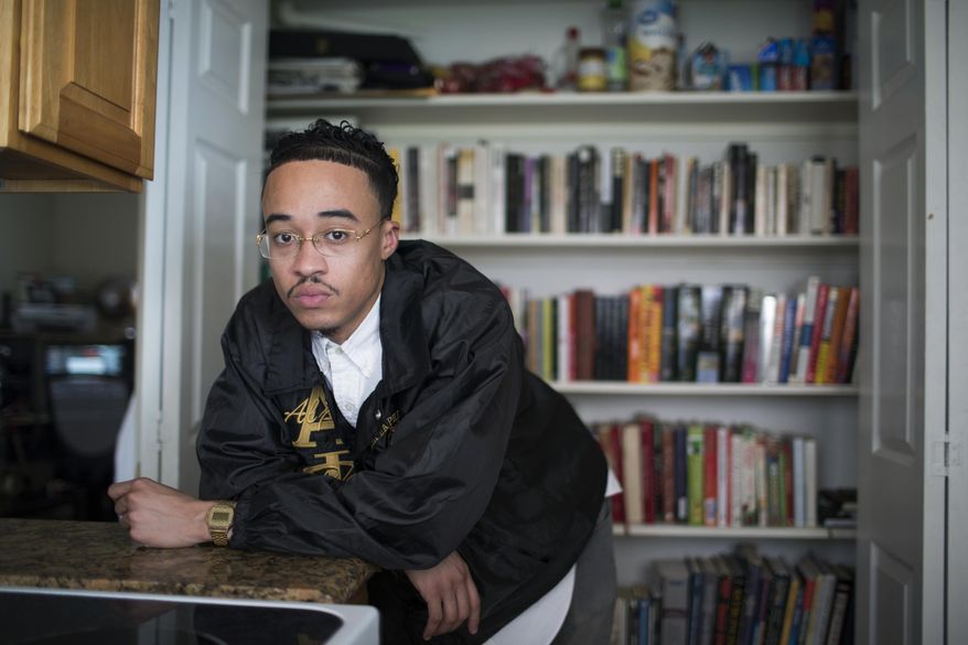 In this Thursday, Aug. 30, 2018, photo, Dieter Cantu poses for a photo in Houston, in front of books he has collected. He takes the books to juvenile detention centers and mentors children who are in juvy now. (Marie D. De Jesus/Houston Chronicle via AP)