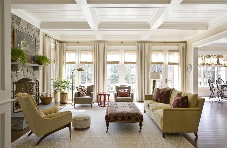 This photo provided by Marika Meyer Interiors shows a living room in McLean, Va. As 2019 approaches, Washington D.C.-based interior designer Marika Meyer sees a trend toward warm neutral colors and antique furniture in warm wood tones, as seen in this living room designed by Meyer. (Angie Seckinger/Marika Meyer Interiors via AP)