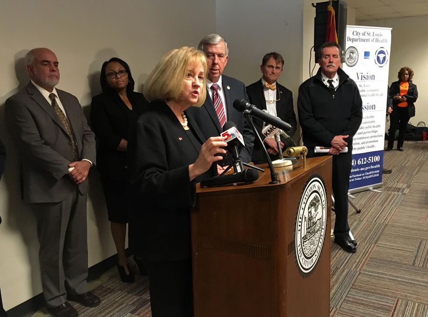 St. Louis Mayor Lyda Krewson speaks at a news conference in St. Louis on Wednesday, Dec. 5, 2018, with Missouri Gov. Mike Parsons and others looking on. Krewson and Parsons both are urging the Missouri Legislature to adopt a prescription drug monitoring plan to combat the opioid epidemic. (AP Photo/Jim Salter)