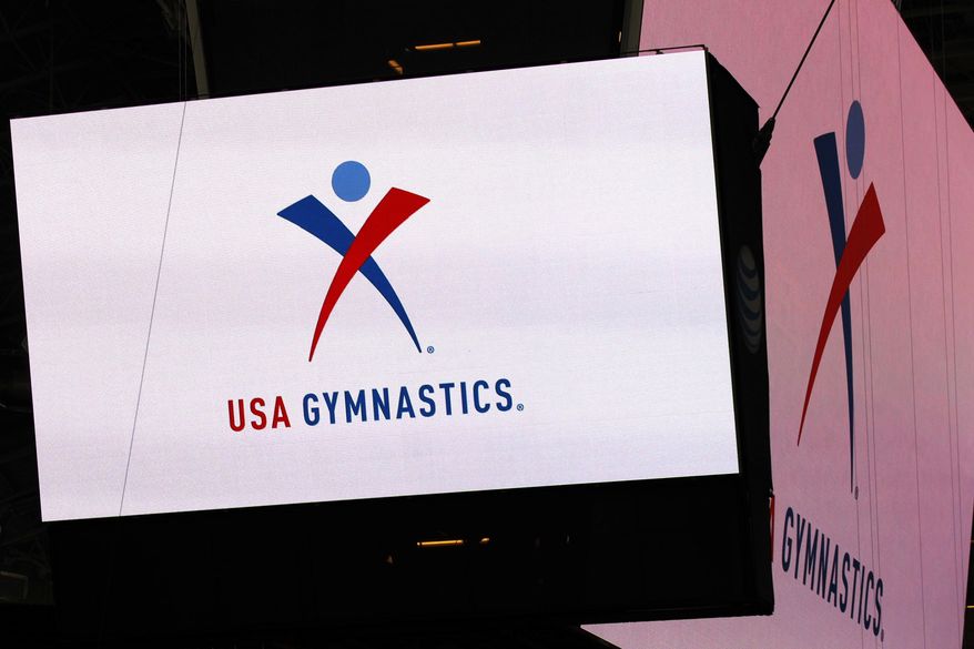 FILE - In this Feb. 26, 2014, file photo, the USA Gymnastics logo is displayed at AT&T Stadium during an news conference announcing in Arlington, Texas. USA Gymnastics has filed a Chapter 11 bankruptcy petition on Wednesday, Dec. 5, 2018, as it attempts to reach settlements in the dozens of sex-abuse lawsuits it faces and to forestall its potential demise at the hands of the U.S. Olympic Committee.(Ron Jenkins/Star-Telegram via AP) **FILE**