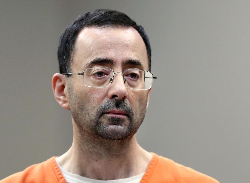 FILE - In this Nov. 22, 2017, file photo, Larry Nassar, a sports doctor accused of molesting girls while working for USA Gymnastics and Michigan State University appears in court in Lansing, Mich., where he pleaded guilty to multiple charges of sexual assault. USA Gymnastics has filed a Chapter 11 bankruptcy petition on Wednesday, Dec. 5, 2018, as it attempts to reach settlements in the dozens of sex-abuse lawsuits it faces and to forestall its potential demise at the hands of the U.S. Olympic Committee. USA Gymnastics faces 100 lawsuits representing 350 athletes in various courts across the country who blame the group for failing to supervise Larry Nassar, a team doctor accused of molesting them. (AP Photo/Paul Sancya, File)