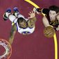 Cleveland Cavaliers&#39; Cedi Osman, right, from Turkey, shoots over Golden State Warriors&#39; Andre Iguodala in the first half of an NBA basketball game, Wednesday, Dec. 5, 2018, in Cleveland. (AP Photo/Tony Dejak)
