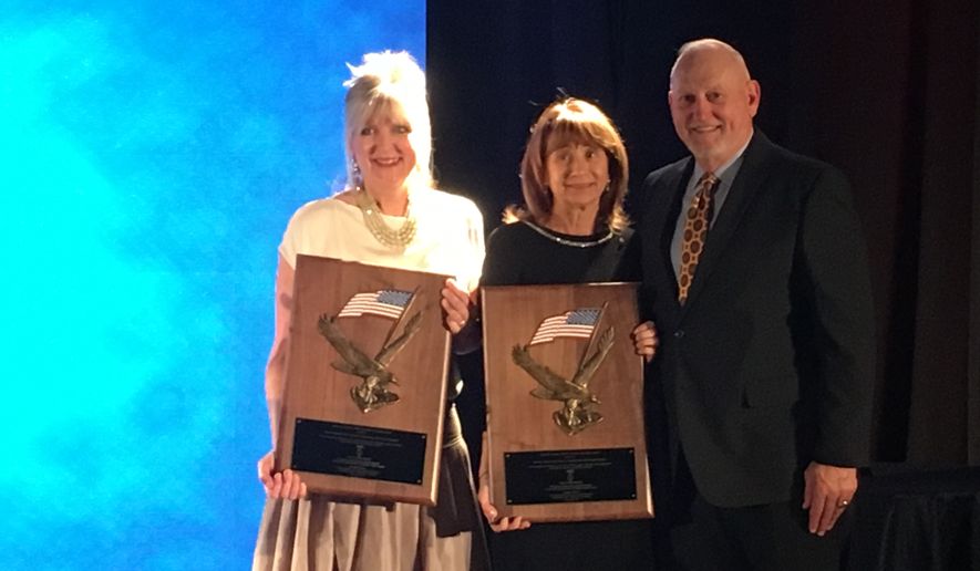 Carmen Gordon (left) and Stephanie Shughart on Thursday night accepted on behalf of their late husbands the Defender of Freedom award from the Freedom Alliance. At right is Army Lt. Gen. William G. Boykin.