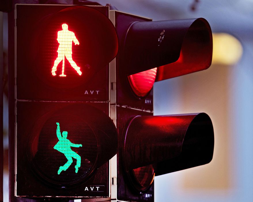 Walking figures depicting late US rock and roll legend Elvis Presley appear on a traffic light switching from green to red in Friedberg near Frankfurt, Germany, Thursday, Dec. 6, 2018. Presley served in Friedberg from October 1958 to March 1960 as a soldier in the US Armed Forces.( AP Photo/Michael Probst)