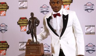 Georgia&#39;s Deandre Baker poses with the trophy after winning the Jim Thorpe Award as top defensive back in college football Thursday, Dec. 6, 2018, in Atlanta. (AP Photo/John Bazemore)