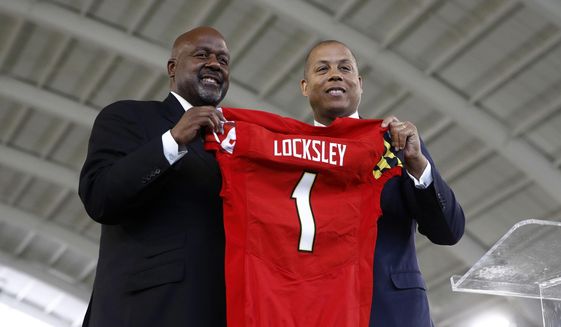 Maryland&#39;s new head football coach Mike Locksley, left, and athletic director Damon Evans pose during an NCAA college football news conference, Thursday, Dec. 6, 2018, in College Park, Md. Locksley, Alabama&#39;s offensive coordinator, will take over at Maryland after the most tumultuous year in the program&#39;s recent history. (AP Photo/Patrick Semansky) ** FILE **