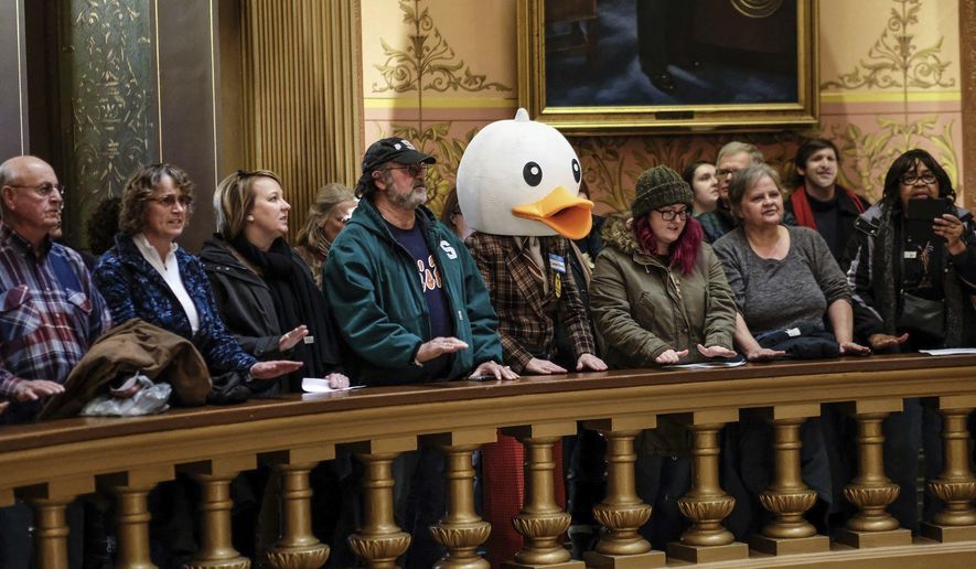 In this Tuesday, Dec. 4, 2018, photo, people gather to protest at the Capitol Rotunda in Lansing, Mich. The incoming Democratic governor of Wisconsin said Wednesday that he plans to make a personal appeal to his defeated rival, Gov. Scott Walker, to veto far-reaching GOP legislation that would restrict the new administration's powers. (Robert Killips/Lansing State Journal via AP)