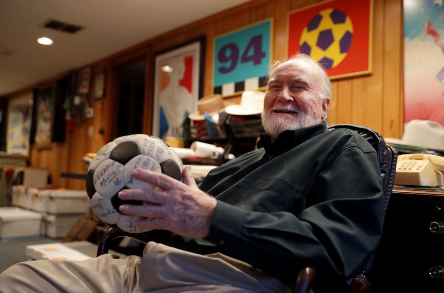 Dick Cecil, vice president and chief architect of the Atlanta Chiefs soccer club, holds a ball signed by the 1968 championship team at his home in Atlanta, Wednesday, Dec. 5, 2018. Cecil still has the championship trophy, tucked away somewhere in his home, a cherished prize that has been reduced to bits and pieces by the ravages of time. (AP Photo/John Bazemore)