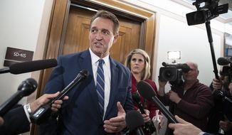 Sen. Jeff Flake, R-Ariz., a member of the Senate Foreign Relations Committee, speaks with reporters as senators are considering multiple pieces of legislation in an effort to formally rebuke Saudi Arabia for the slaying of journalist Jamal Khashoggi, on Capitol Hill in Washington, Thursday, Dec. 6, 2018.  (AP Photo/J. Scott Applewhite)