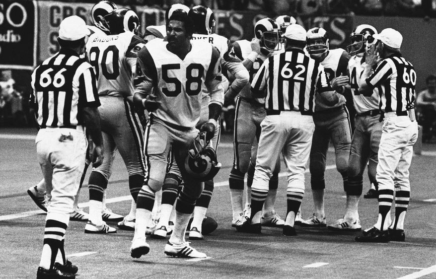 FILE - In this Oct. 30, 1977, file photo, Los Angeles Rams linebacker Isiah Robertson (58) complains about a call during an NFL football game against the New Orleans Saints in New Orleans. Former two-time All-Pro linebacker Robertson was killed when the limousine he was driving skidded on a rain-slicked curve on a dark, rural East Texas highway and was hit by two other vehicles. The Texas Department of Public Safety reports the crash happened Thursday, Dec. 6, 2018. (AP Photo/File)