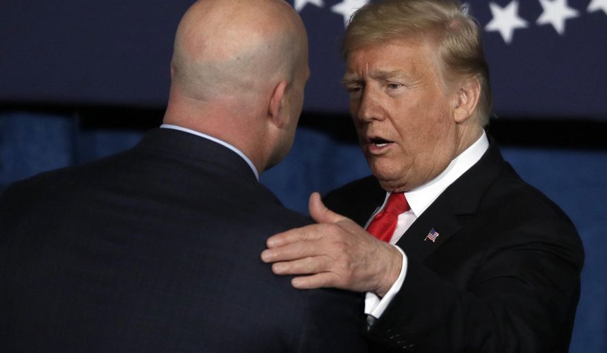 President Donald Trump greets Acting Attorney General Matthew Whitaker, left, before speaking at the Project Safe Neighborhoods National Conference in Kansas City, Mo., Friday, Dec. 7, 2018. (AP Photo/Orlin Wagner) **FILE**