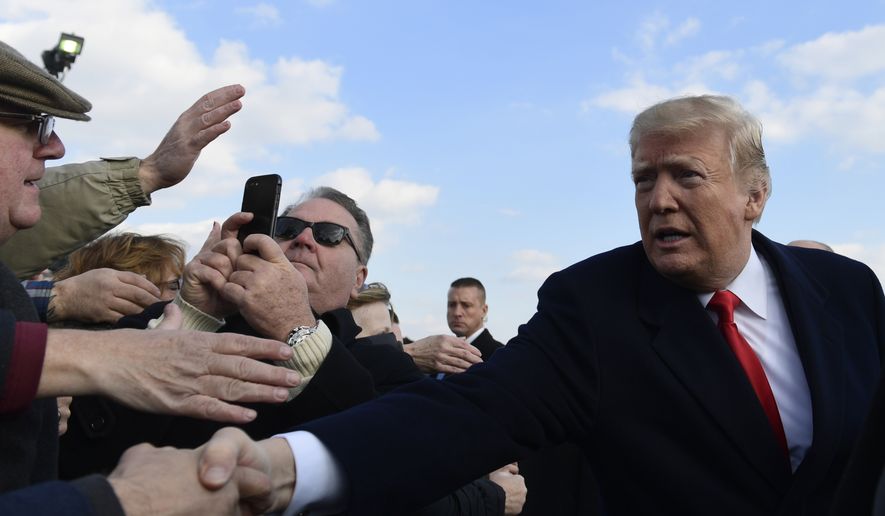 President Donald Trump greets people after arriving via Air Force One at Philadelphia International Airport in Philadelphia, Saturday, Dec. 8, 2018. Trump is attending the Army-Navy football game. (AP Photo/Susan Walsh) ** FILE **