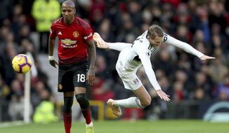 Manchester United&#39;s Ashley Young, left and Fulham&#39;s Andre Schurrle battle for the ball during the English Premier League soccer match between Manchester United and Fulham, at Old Trafford, Manchester, England, Saturday, Dec. 8, 2018. (Barrington Coombs/PA via AP)