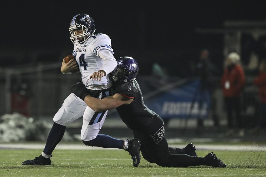 Maine quarterback Chris Ferguson (14) is sacked by Weber State's Adam Rodriguez (9) during the second half in a quarterfinal of the NCAA Football Championship Subdivision playoffs Friday, Dec. 7, 2018, in Ogden, Utah. (Matt Herp/Standard-Examiner via AP)