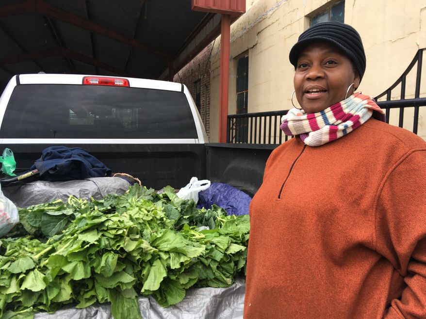 Elaine Blair sells collard greens, mustard greens and turnip greens out of the back of her pickup truck Friday, Dec. 7, 2018, in Canton, Miss. Blair, who lost a 2015 election for a seat on the Canton Board of Aldermen, says she was not surprised to hear that seven people, including the person who defeated her, are now facing voter fraud charges connected to the 2017 Canton city elections. AP Photo/Emily Wagster Pettus)