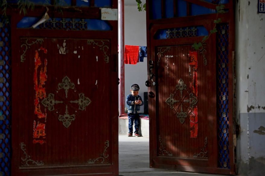 As a Uighur child played alone, China's Communist Party was showcasing Hotan Unity New Village, part of its efforts to tame Xinjiang province, the heartland of the country's often restive Uighur Muslim minority. (Associated Press/File)