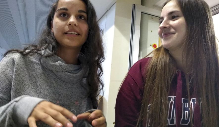 In this Oct. 3, 2018 photo 16-year-old Seray Aytar and Melek Karakoc speak in their school in Simmerin near Vienna, Austria. The two best friends, born in Austria, were raised by women who, despite coming from Turkey as teens, still can&#x27;t manage basic German. Whether in class in Austria or on vacation in Turkey, Seray and Melek feel caught between two uncomprehending worlds. (AP Photo/Giovanna Dell&#x27;Orto)