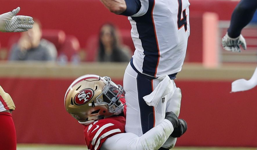 Denver Broncos quarterback Case Keenum throws the ball as San Francisco 49ers outside linebacker Elijah Lee makes a tackle during the first half of an NFL football game Sunday, Dec. 9, 2018, in Santa Clara, Calif. (AP Photo/Josie Lepe)