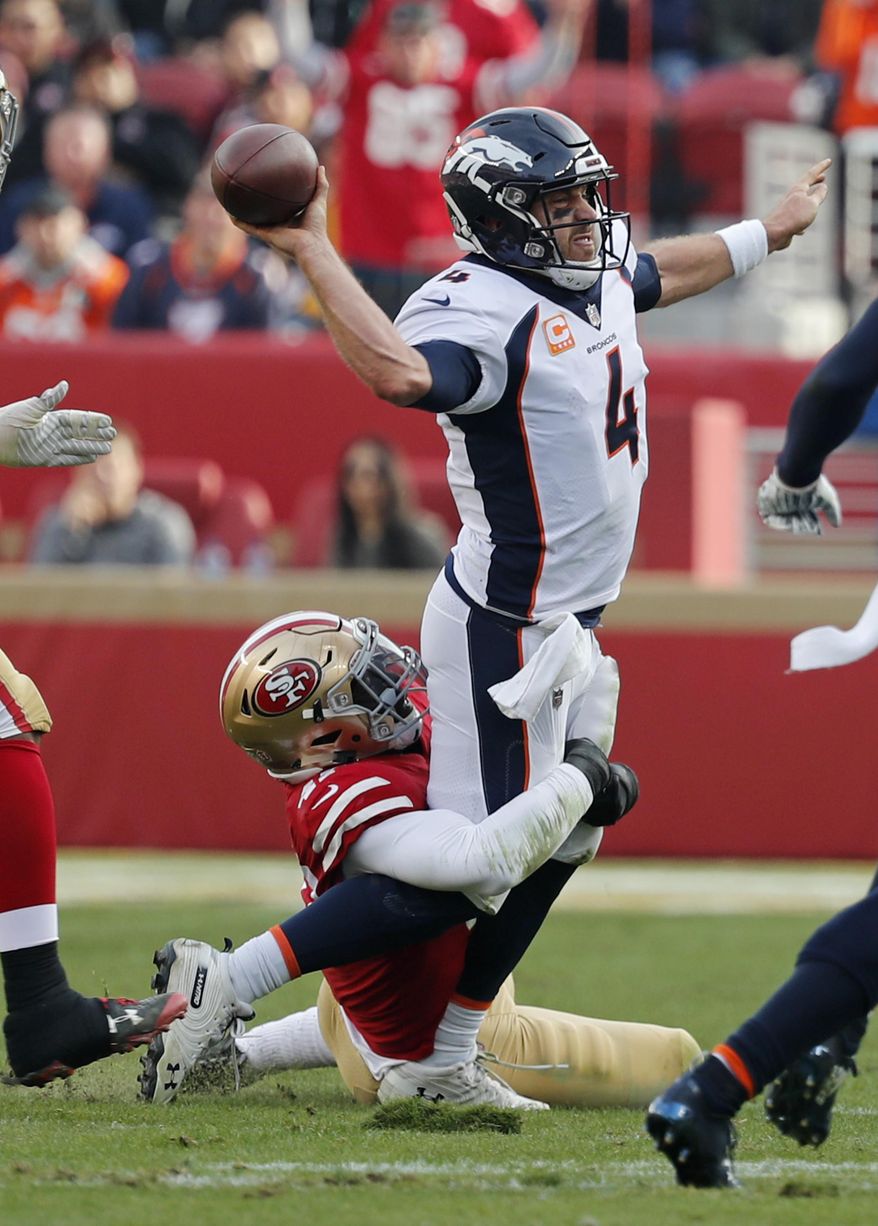 Denver Broncos quarterback Case Keenum throws the ball as San Francisco 49ers outside linebacker Elijah Lee makes a tackle during the first half of an NFL football game Sunday, Dec. 9, 2018, in Santa Clara, Calif. (AP Photo/Josie Lepe)
