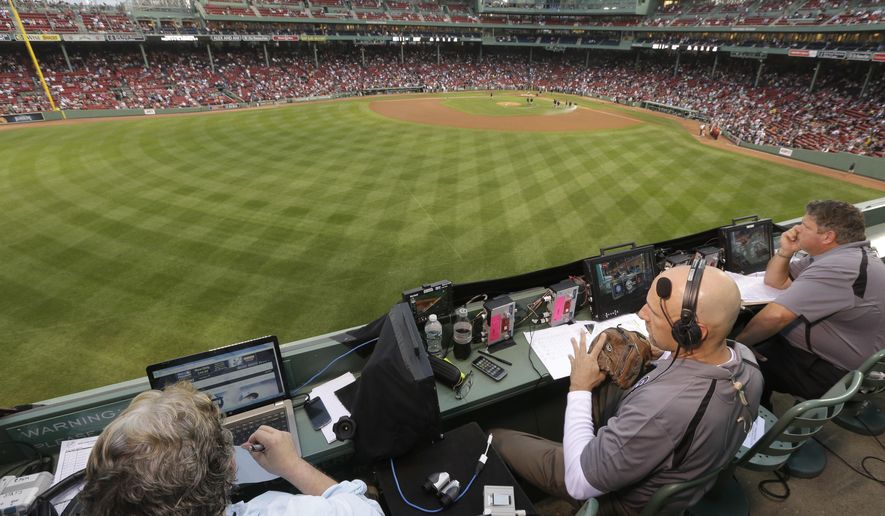 FILE - In this Aug. 3, 2014, file photo, ESPN television broadcasters prepare to cover a baseball game between the New York Yankees and the Boston Red Sox from the top of the Green Monster at Fenway Park, moments before the game, in Boston. ESPN plans to announce it will move up the starting time of the nationally televised game by one hour, with the first pitch planned for shortly after 7 p.m. EDT. The network intends to make the announcement on Monday, Dec. 10, 2018, at the winter meetings, a person familiar with the decision told The Associated Press. The person spoke on condition of anonymity Sunday because the announcement had not yet been made. (AP Photo/Steven Senne, File)