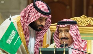 In this photo released by the state-run Saudi Press Agency, Saudi Crown Prince Mohammed bin Salman, left, speaks to his father, King Salman, right, at a meeting of the Gulf Cooperation Council in Riyadh, Saudi Arabia, Sunday, Dec. 9, 2018. Leaders of Gulf Arab countries, including those boycotting Qatar, met on Sunday in Saudi Arabia&#39;s capital for a regional summit, a gathering that Qatar&#39;s ruling emir choose not to attend amid the dispute. (Saudi Press Agency via AP) ** FILE **