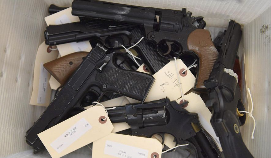 This June 2, 2018, file photo provided by the Chicago Police Department shows weapons turned in by residents in a gun buyback program co-sponsored with the New Life Covenant Church Southeast in the 6th Police District. More than 400 guns and rifles were handed over in exchange for $100 gift cards. (CPD via AP) ** FILE **