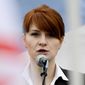 In this April 21, 2013, file photo, Maria Butina, leader of a pro-gun organization in Russia, speaks to a crowd during a rally in support of legalizing the possession of handguns in Moscow, Russia. Prosecutors say they have “resolved” a case against Butina accused of being a secret agent for the Russian government, a sign that she likely has taken a plea deal. The information was included in a court filing Monday. (AP Photo/File)