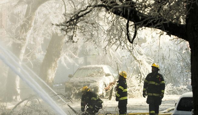 Firefighters battle a fire at an apartment building in Philadelphia, Monday, Dec. 10, 2018. The early-morning blaze in the city's Overbrook section has displaced dozens of residents. (AP Photo/Matt Rourke)
