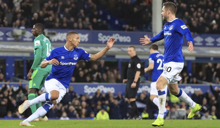 Everton's Richarlison, left, celebrates scoring his side's first goal of the game against Watford during the English Premier League soccer match at Goodison Park, Liverpool, England, Monday Dec. 10, 2018. (Peter Byrne/PA via AP)