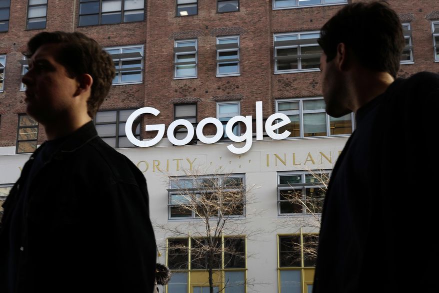 In this Dec. 4, 2017 file photo, people walk by Google offices in New York. (AP Photo/Mark Lennihan, File)