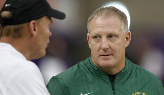 FILE - In this Oct. 6, 2018, file photo, North Dakota State head coach Chris Klieman, right, talks with Northern Iowa head coach Mark Farley, left, before an NCAA college football game in Cedar Falls, Iowa. Kansas State hired Klieman to lead its football program Monday, Dec. 10, 2018, passing the reins from retired Hall of Fame coach Bill Snyder to someone with three Football Championship Subdivision titles but little Big 12 experience. (AP Photo/Charlie Neibergall, File)