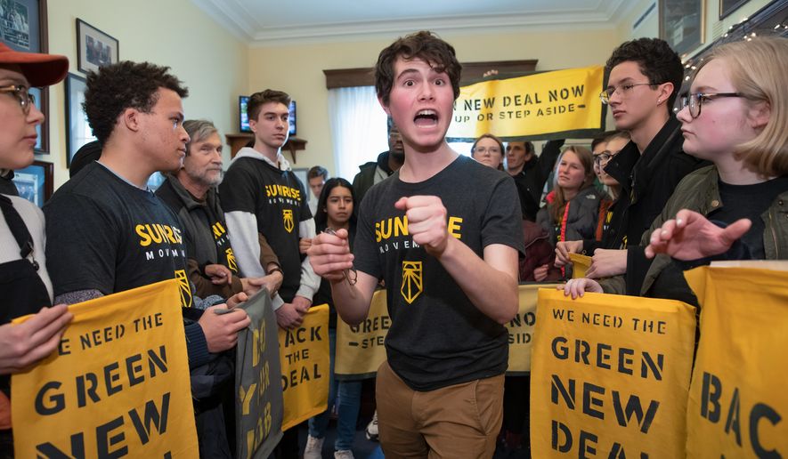 Jeremy Ornstein of Watertown, Mass., center, cheers on fellow environmental activists as they occupy the office of Rep. Steny Hoyer, D-Md., the incoming majority leader, as they try to pressure Democratic support for a sweeping agenda to fight climate change, on Capitol Hill in Washington, Monday, Dec. 10, 2018. (AP Photo/J. Scott Applewhite) ** FILE **