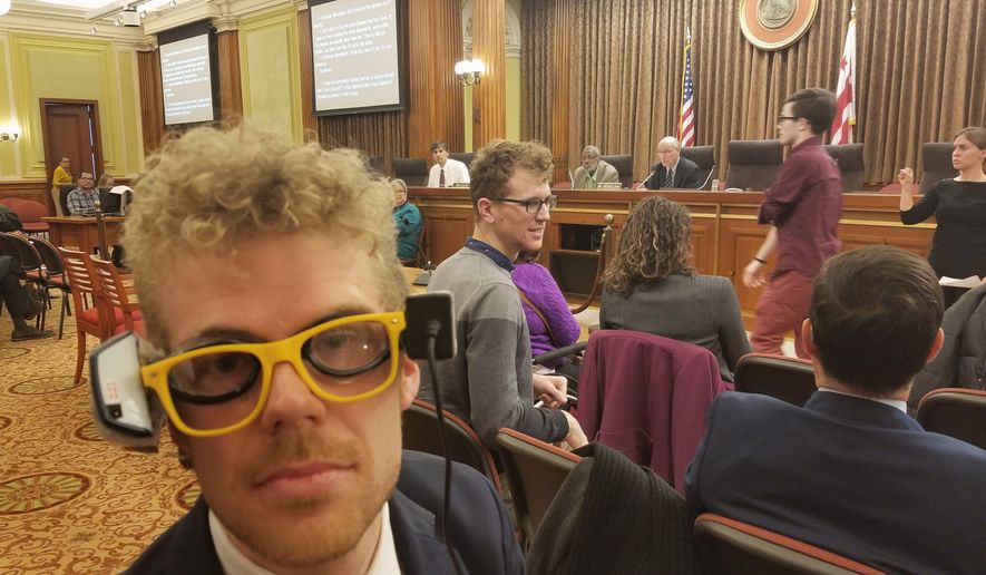 Photo by Julia Airey / The Washington Times 
  
 Rob Dooling, a deaf Advisory Neighborhood Commissioner, wears a pair of mock captioning glasses he made for a D.C. Council hearing on Dec. 11, 2018. Lawmakers are considering legislation that would require movie theaters to screen more films with open captioning after deaf and hard-of-hearing viewers. Advocates say that many captioning glasses are broken or too heavy to wear comfortably. (Photo by Julia Airey)