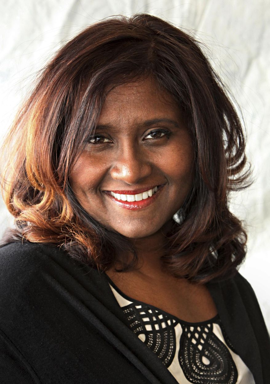 In this March 27, 2014 photo, Daisy Veerasingham, Senior Vice President for The Associated Press, poses for a photo in New York. The AP named Veerasingham as its chief revenue officer on Tuesday, Dec. 11, 2018, a new position that will consolidate global revenue operations under one director as the news cooperative widens its customer base beyond traditional media. (AP Photo/Santos Chaparro)
