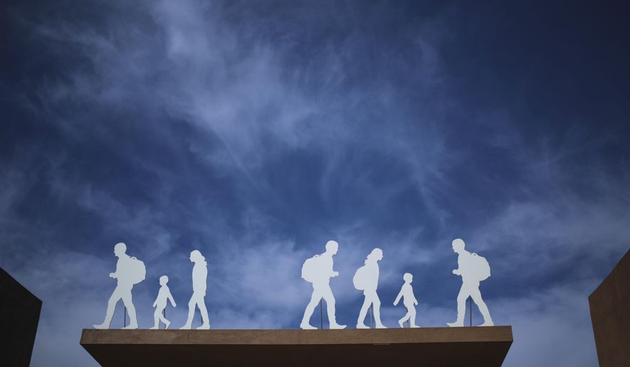 An installation depicting migrants is placed at the entrance of the UN Migration Conference in Marrakech, Morocco, Tuesday, Dec.11, 2018. Top U.N. officials and government leaders from about 150 countries are uniting around an agreement on migration, while finding themselves on the defensive about the non-binding deal amid criticism and a walkout from the United States and some other countries. (AP Photo/Mosa'ab Elshamy)