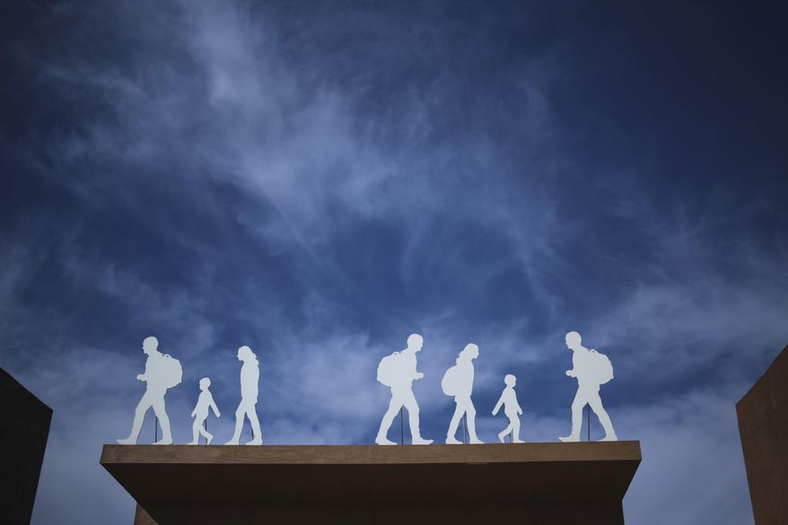 An installation depicting migrants is placed at the entrance of the UN Migration Conference in Marrakech, Morocco, Tuesday, Dec.11, 2018. Top U.N. officials and government leaders from about 150 countries are uniting around an agreement on migration, while finding themselves on the defensive about the non-binding deal amid criticism and a walkout from the United States and some other countries. (AP Photo/Mosa'ab Elshamy)