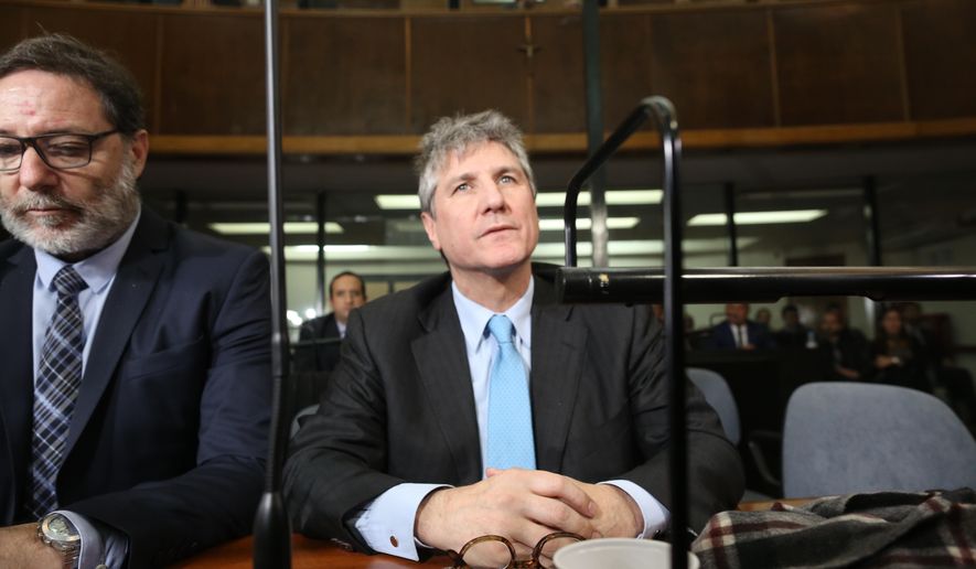 FILE - In this Aug. 7, 2018 file photo, Argentina's former Vice President Amado Boudou, right, and his lawyer Alejandro Rua sit in court in Buenos Aires, Argentina before Boudou was sentenced to five years and 10 months in prison for bribery and conducting business incompatible with public office. On Tuesday, Dec. 11, 2018, a court in Argentina released Boudou from prison under bail, saying that the sentence is not firm since it is still being appealed. (AP Photo/Sebastian Pani, File)