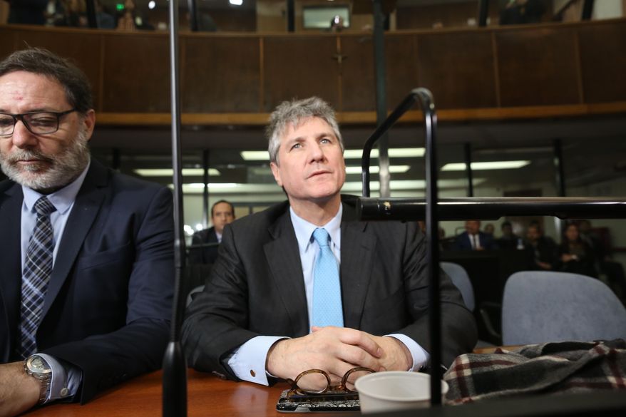 FILE - In this Aug. 7, 2018 file photo, Argentina's former Vice President Amado Boudou, right, and his lawyer Alejandro Rua sit in court in Buenos Aires, Argentina before Boudou was sentenced to five years and 10 months in prison for bribery and conducting business incompatible with public office. On Tuesday, Dec. 11, 2018, a court in Argentina released Boudou from prison under bail, saying that the sentence is not firm since it is still being appealed. (AP Photo/Sebastian Pani, File)