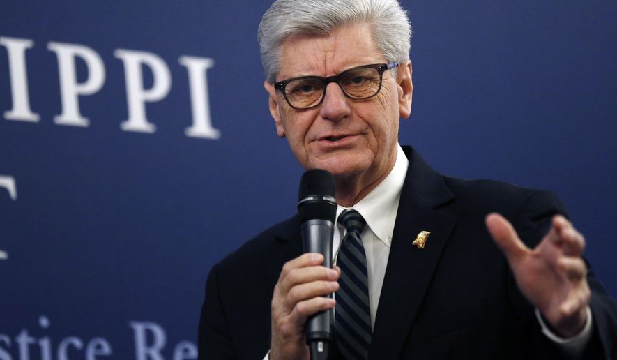 Gov. Phil Bryant says he'll support efforts to reduce the number of Mississippians in prison in the 2019 legislative session during a discussion on criminal justice reform, at the Mississippi Summit on Criminal Justice Reform in Jackson, Miss., Tuesday, Dec. 11, 2018. The meeting was put on by a coalition of groups that favor changes to reduce harshness in the criminal justice system. (AP Photo/Rogelio V. Solis)