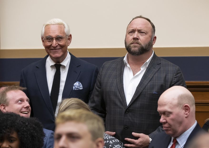 Roger Stone, a confidant of President Donald Trump, left, and radio show host and conspiracy theorist Alex Jones, right, enter the House Judiciary Committee hearing room to hear testimony by Google CEO Sundar Pichai, on Capitol Hill in Washington, Tuesday, Dec. 11, 2018. (AP Photo/J. Scott Applewhite)
