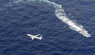 FILE - In this Dec. 6, 2018, file photo, Japan&#39;s Coast Guard ship, top, and U.S. military plane are seen at sea off Kochi, southwestern Japan, during a search and rescue operation for missing crew members of a U.S. Marine refueling plane and fighter jet. The U.S. Marine Corps have declared that five crewmembers dead after their aircraft crashed last week off Japan’s southern coast and that their search has ended. (Kyodo News via AP, File)