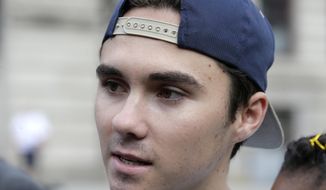 FILE - In this Aug. 23, 2018, file photo, David Hogg, a survivor of the school shooting at Marjory Stoneman Douglas High School, in Parkland, Fla., speaks with reporters before a march in Worcester, Mass. Hogg&#39;s remarks during a CNN interview is among those on a Yale Law School librarian&#39;s list of the most notable quotes of 2018: &amp;quot;We&#39;re children. You guys, like, are the adults. You need to take some action and play a role. Work together, come over your politics and get something done.&amp;quot; (AP Photo/Steven Senne, File)