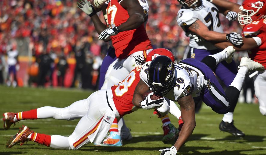 Baltimore Ravens running back Kenneth Dixon (30) scores a touchdown against Kansas City Chiefs safety Ron Parker (38) during the first half of an NFL football game in Kansas City, Mo., Sunday, Dec. 9, 2018. (AP Photo/Ed Zurga)