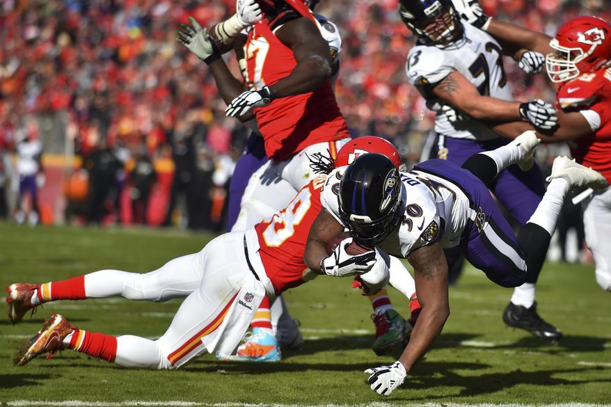 Baltimore Ravens running back Kenneth Dixon (30) scores a touchdown against Kansas City Chiefs safety Ron Parker (38) during the first half of an NFL football game in Kansas City, Mo., Sunday, Dec. 9, 2018. (AP Photo/Ed Zurga)