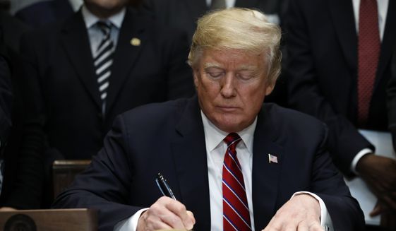President Donald Trump signs an executive order establishing the White House Opportunity and Revitalization Council, in the Roosevelt Room of the White House, Wednesday, Dec. 12, 2018, in Washington. (AP Photo/Jacquelyn Martin) ** FILE **