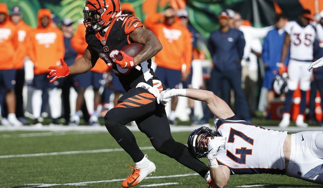 FILE - In this Dec. 2,2018, file photo, Cincinnati Bengals running back Joe Mixon (28) breaks a tackle-attempt by Denver Broncos inside linebacker Josey Jewell (47) in the first half of an NFL football game, in Cincinnati. Mixon has been one of the few bright spots during the Bengals&#x27; eight-game implosion. (AP Photo/Frank Victores, File)