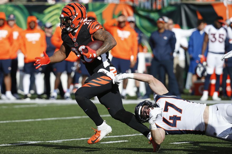 FILE - In this Dec. 2,2018, file photo, Cincinnati Bengals running back Joe Mixon (28) breaks a tackle-attempt by Denver Broncos inside linebacker Josey Jewell (47) in the first half of an NFL football game, in Cincinnati. Mixon has been one of the few bright spots during the Bengals' eight-game implosion. (AP Photo/Frank Victores, File)