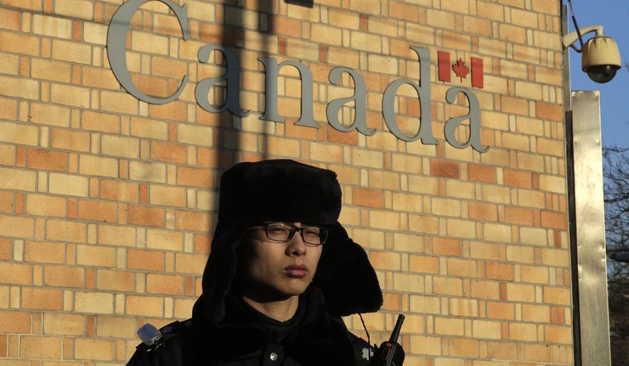 A policeman stands watch outside the Canadian Embassy in Beijing, Wednesday, Dec. 12, 2018. A Canadian court granted bail on Tuesday to a top Chinese executive arrested at the United States&#x27; request in a case that has set off a diplomatic furor among the three countries and complicated high-stakes U.S.-China trade talks. (AP Photo/Andy Wong)